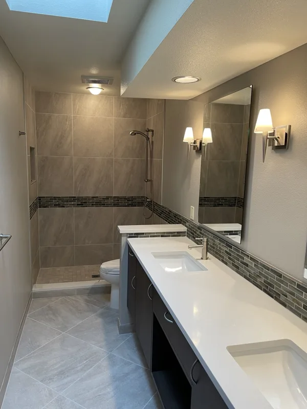 Shower wall tile with a contrasting accent band.