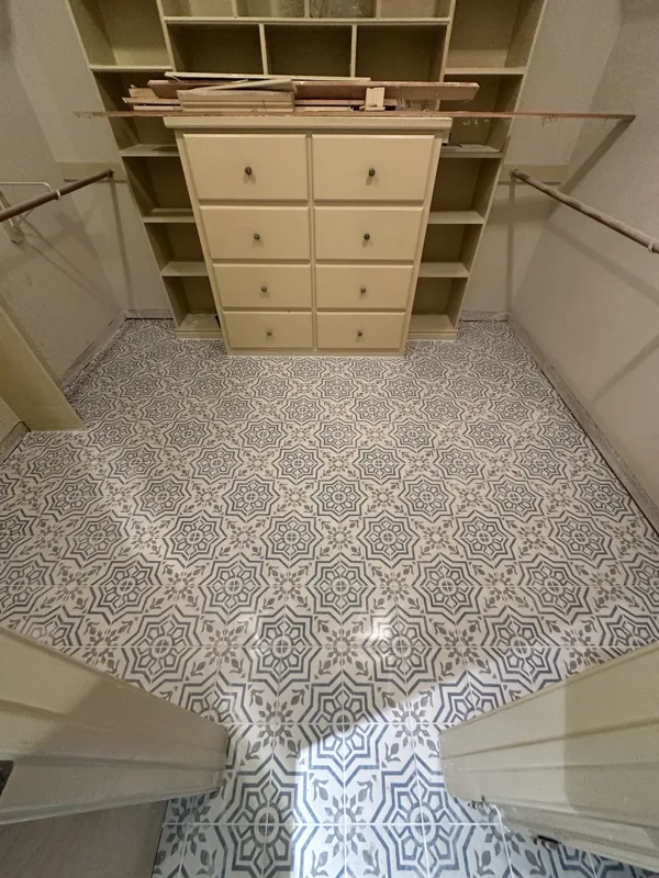 Decorative floor tile around built-in cabinetry.