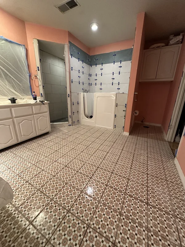 Patterned floor tile and shower work in progress.