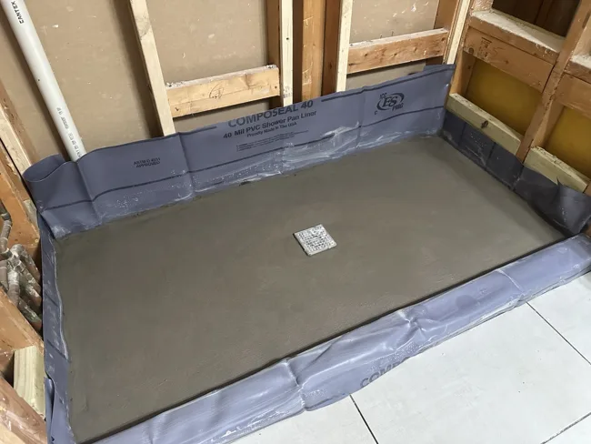 A shower base during preparation, before tile installation.