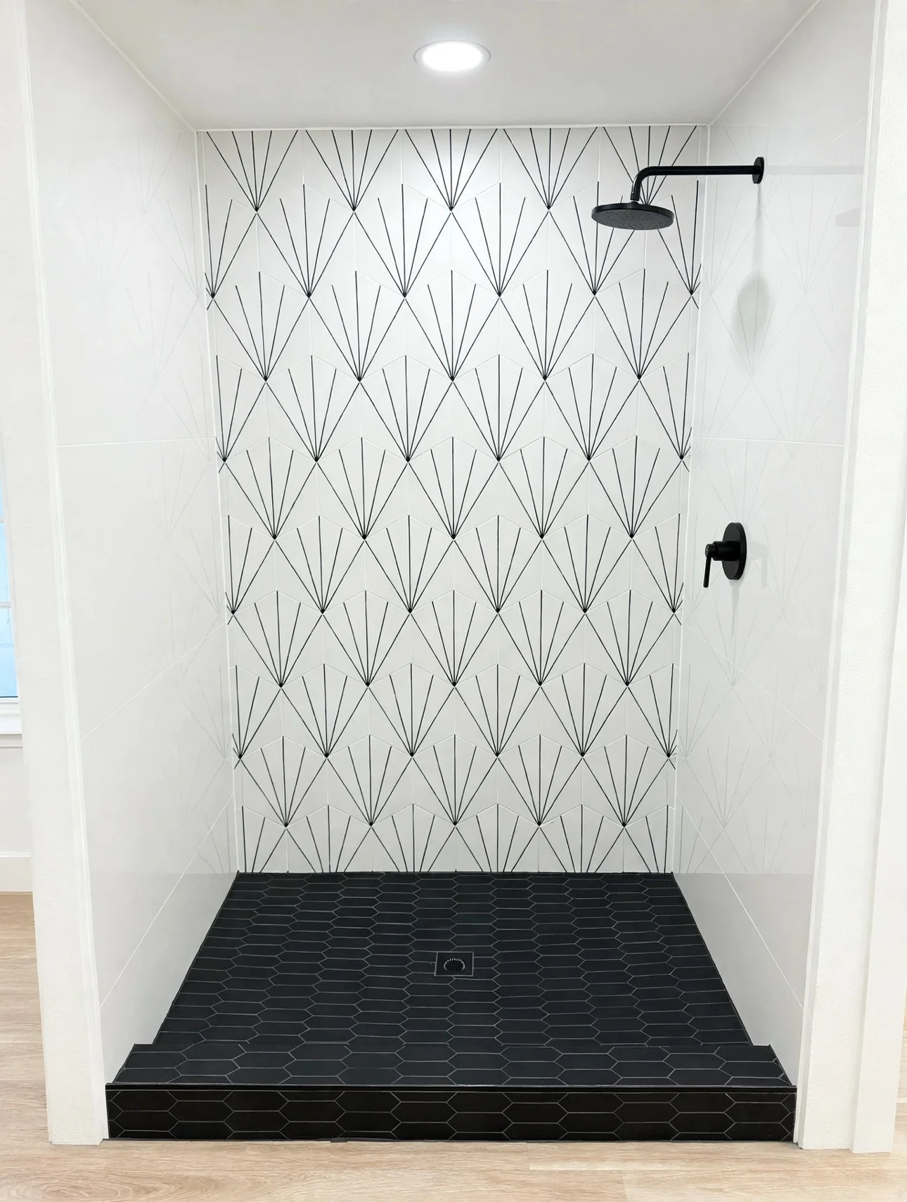 White deco-pattern tile shower wall with a black hex tile floor